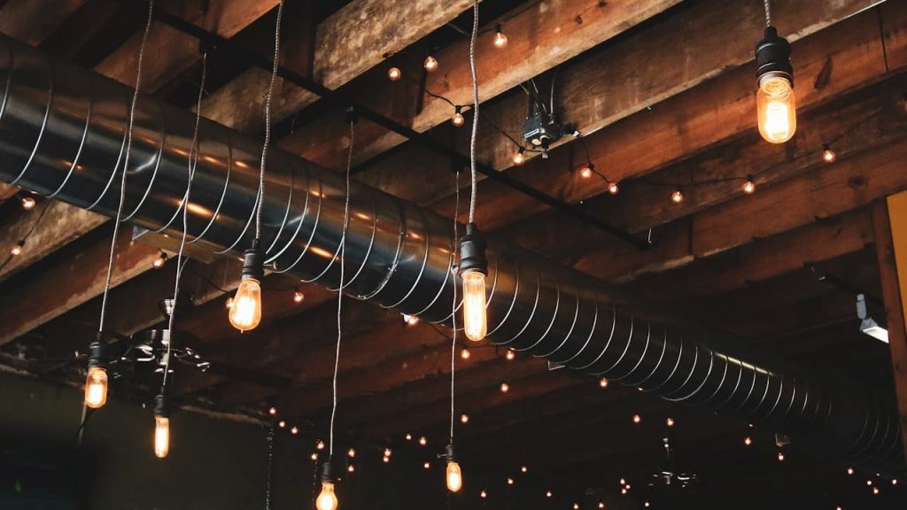 Close-up of a textured home ceiling interior, showing beams, ducts, and fixtures against the ceiling surface