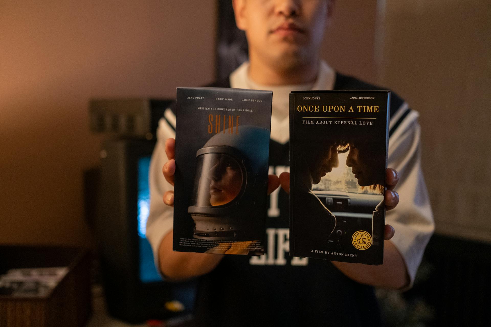 Man holding movies on videotapes