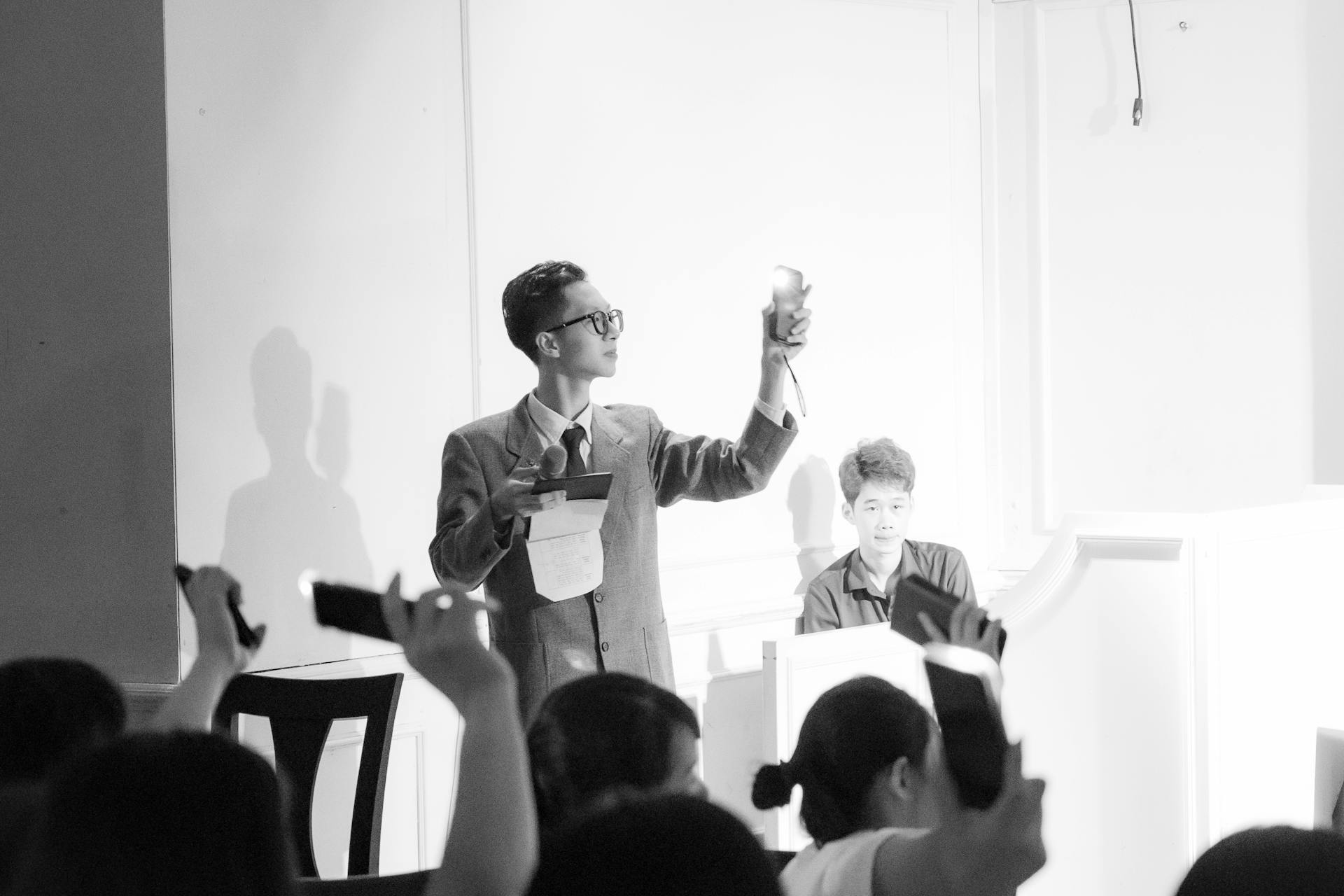 A black and white photograph of an auction scene with bidders