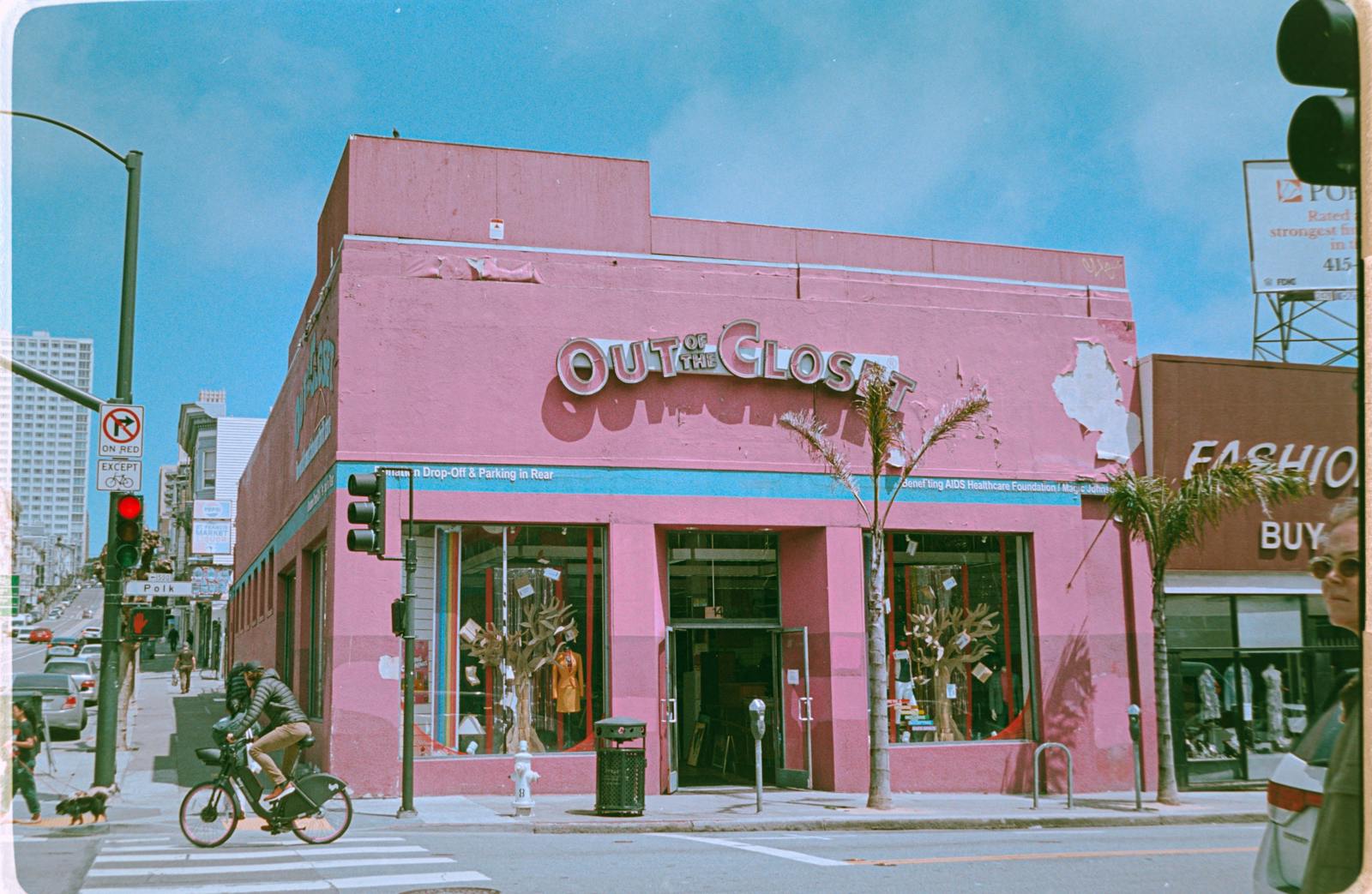 Colorful urban intersection in San Francisco at Out of the Closet thrift store with street life and architecture.