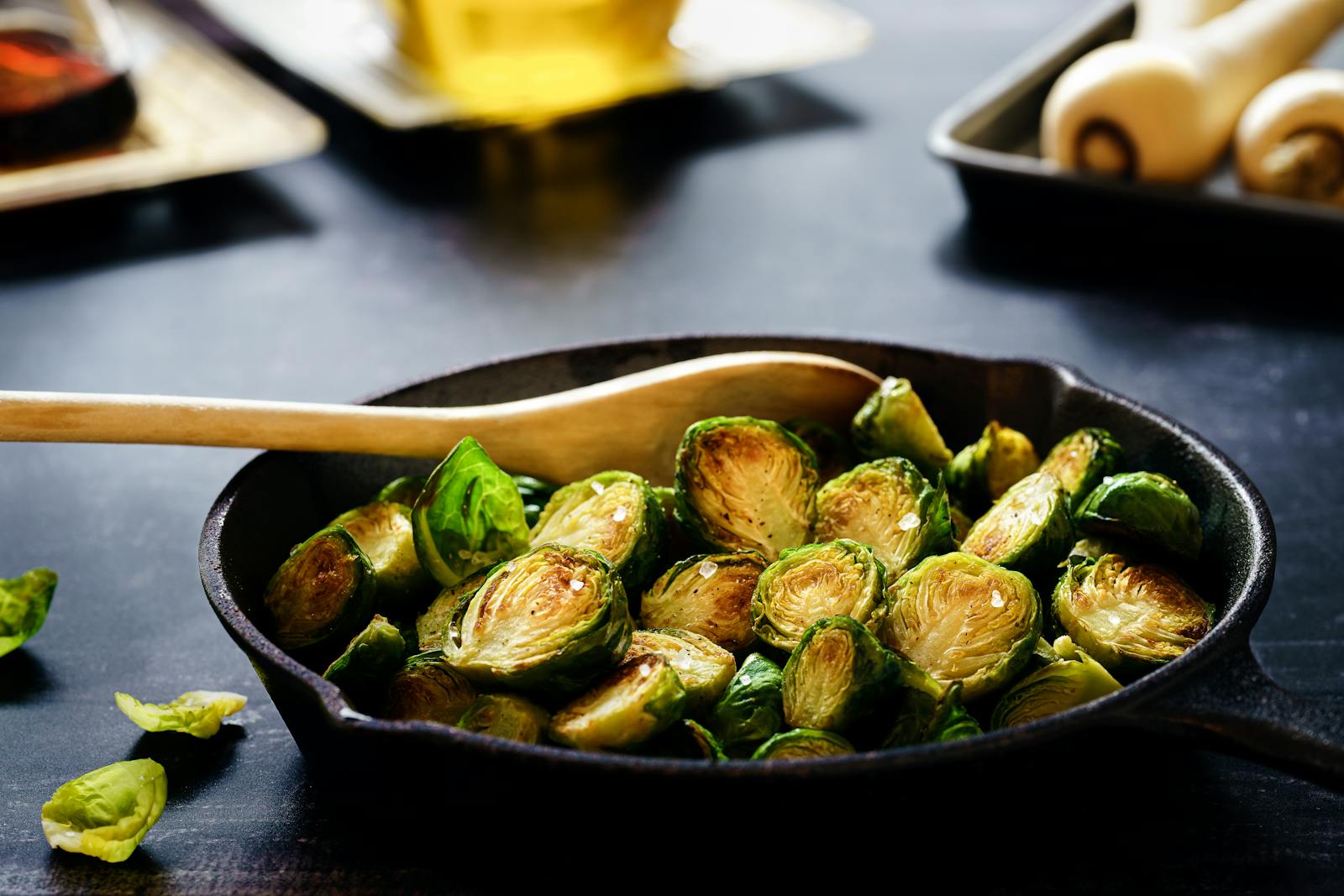 Close-up of delicious roasted Brussels sprouts in a cast iron skillet, perfect for a healthy meal.