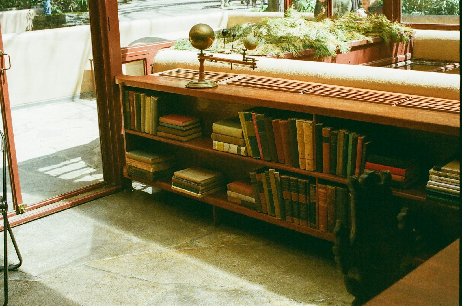 Bookshelves and furniture are seen inside a home.