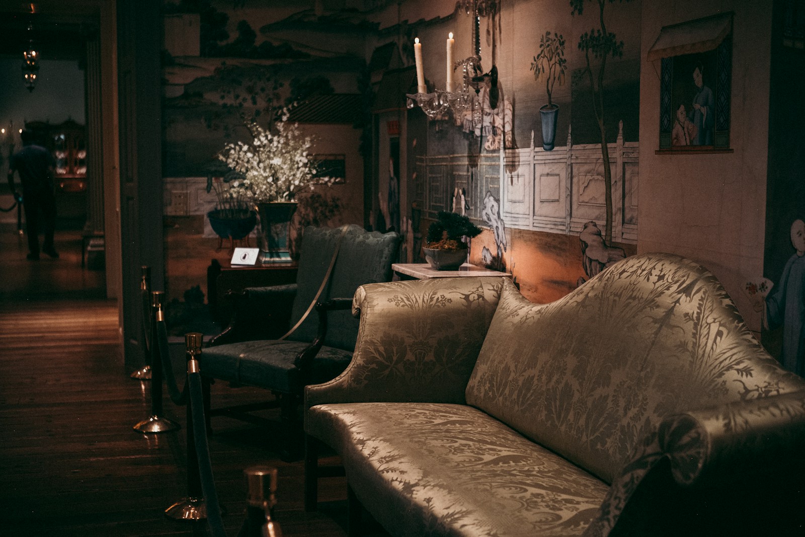 Antique sofa and chairs in a dimly lit room.