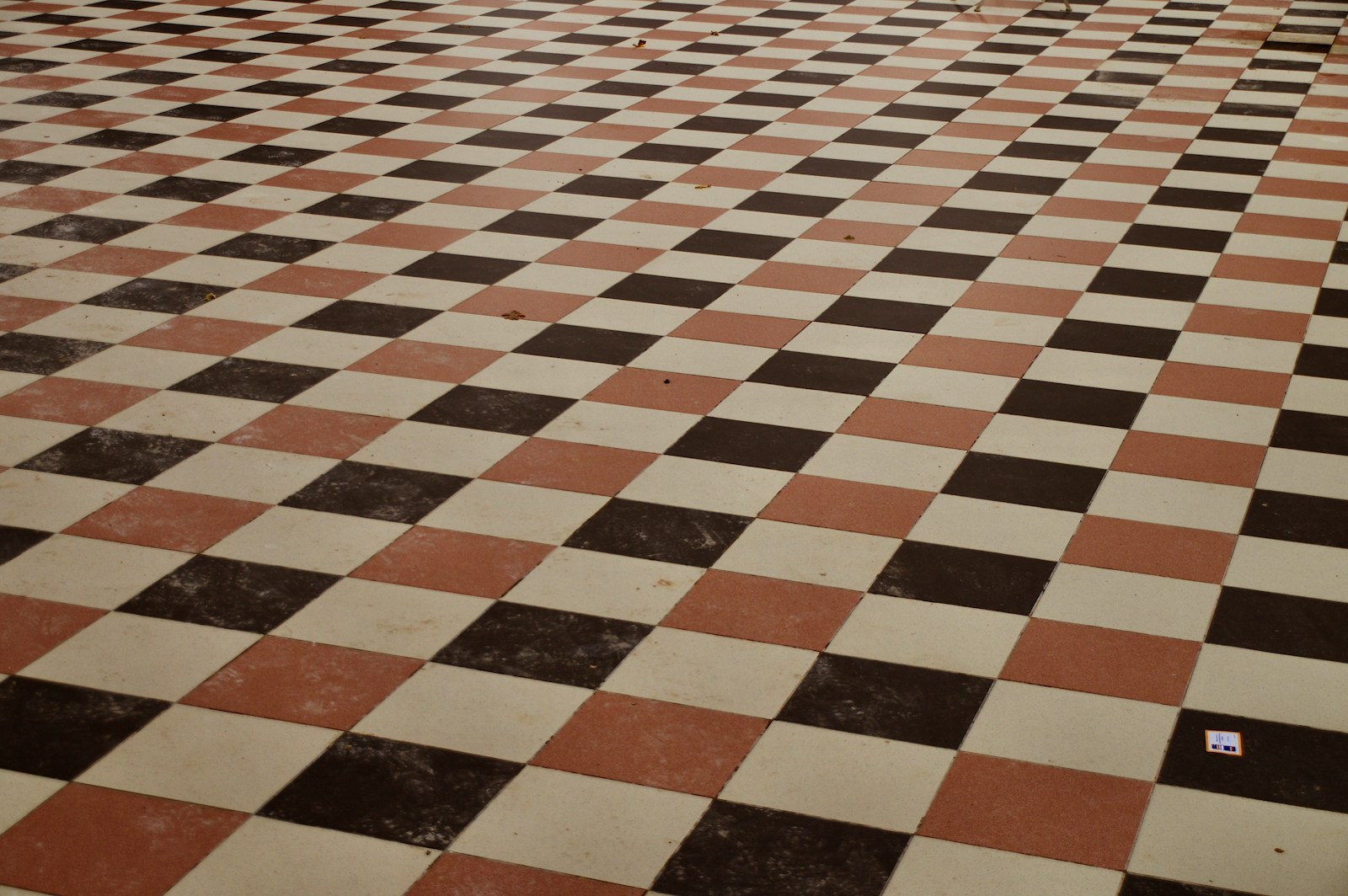 a black and white checkered floor with a clock on it