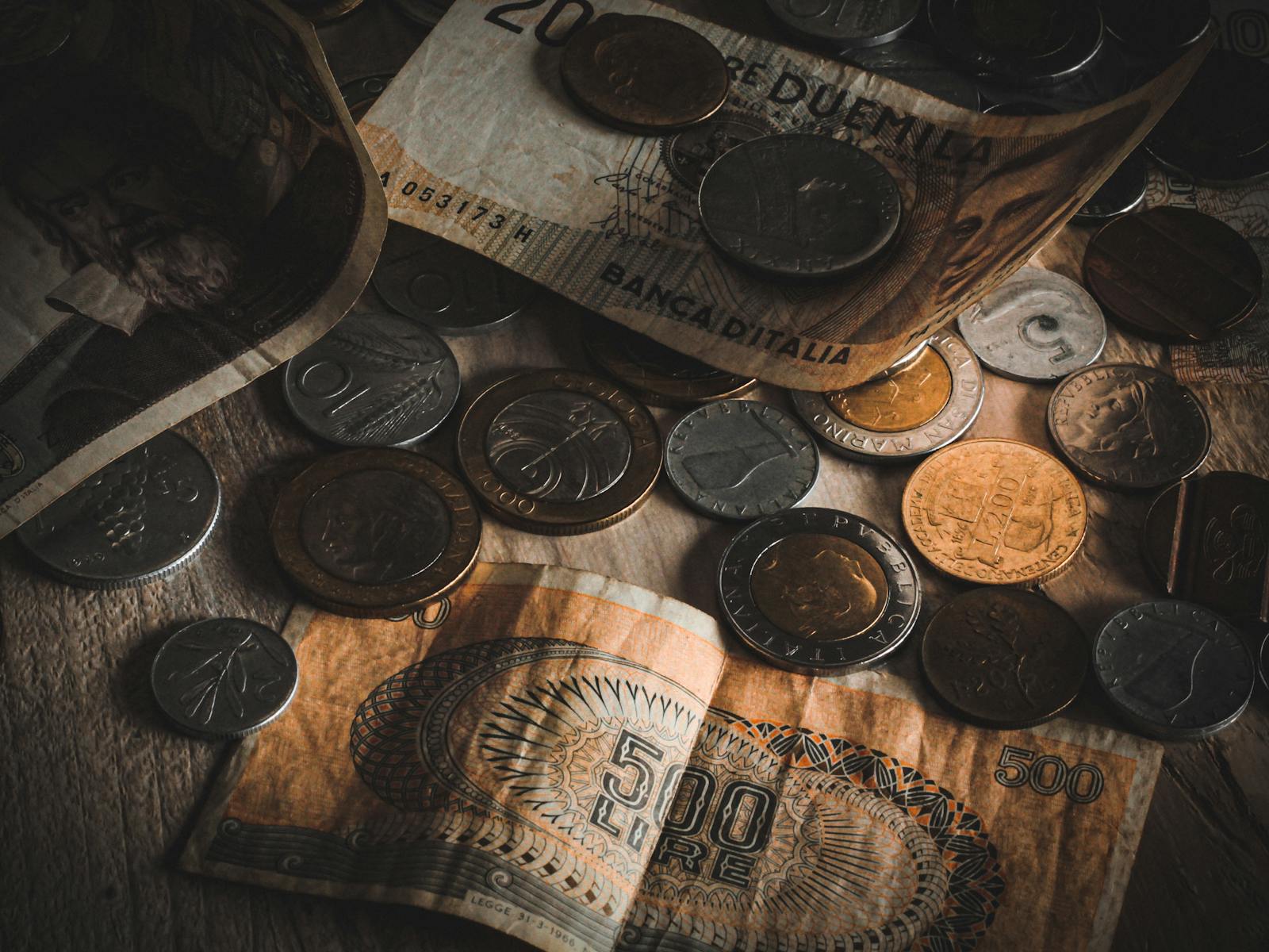A close-up view of assorted vintage coins and banknotes on a table.