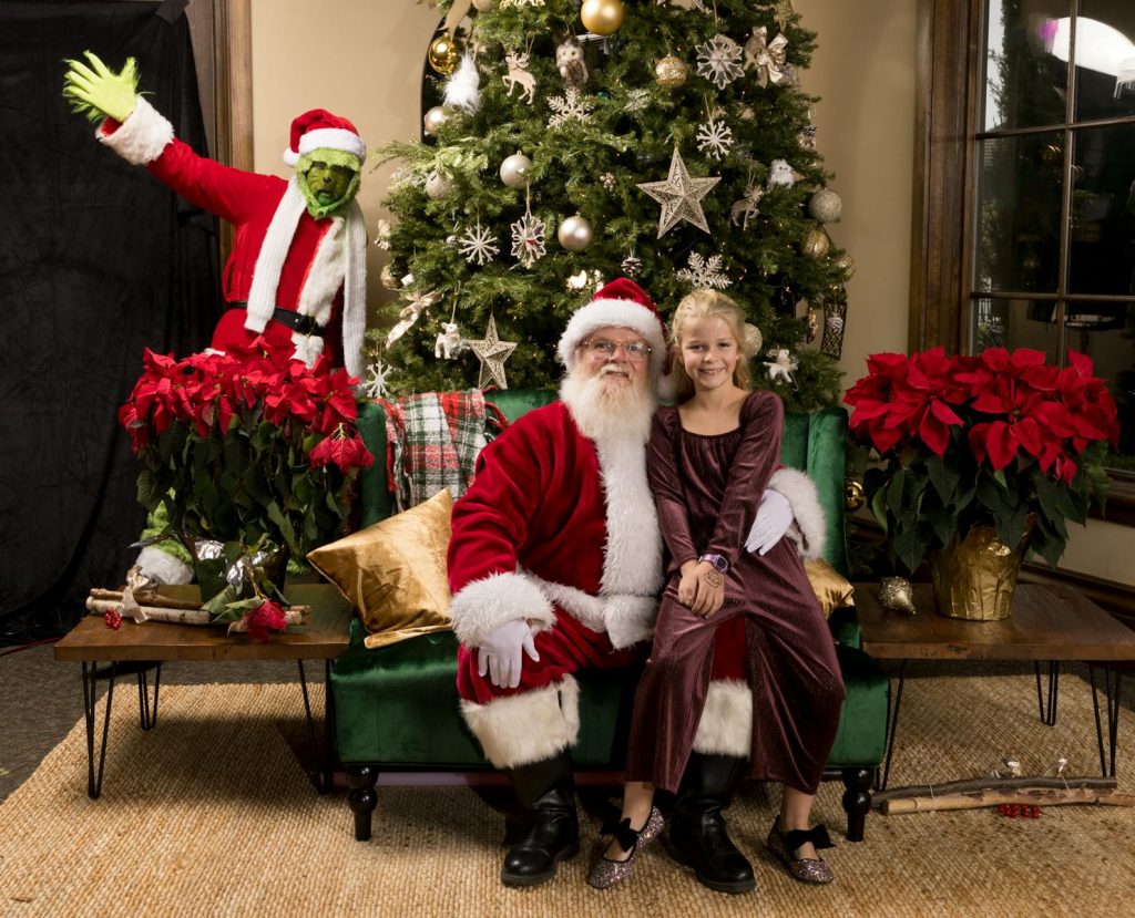 Joyful holiday photo of Santa and child by a decorated tree with holiday ambiance