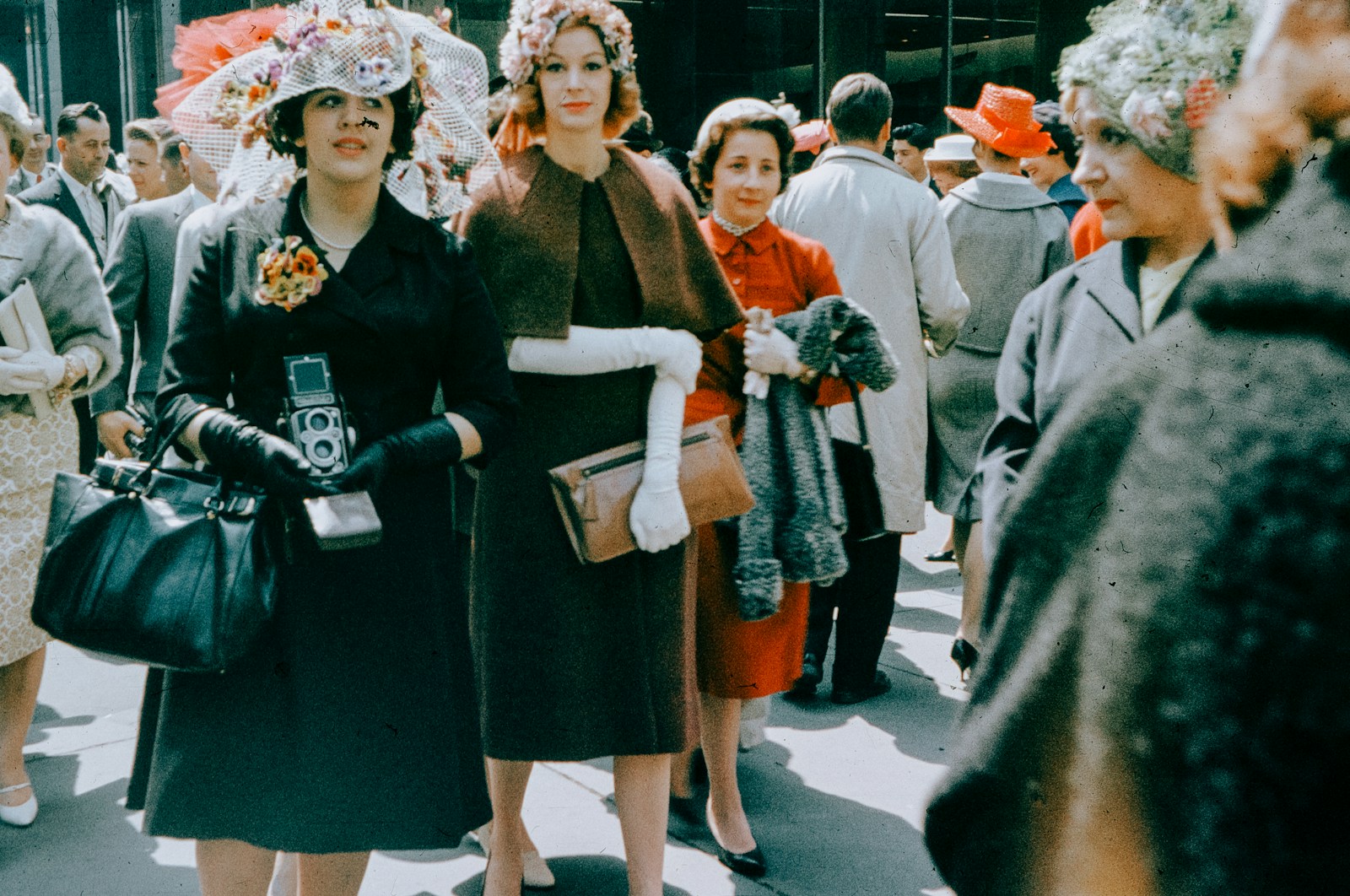 Women in vintage hats and dresses on street