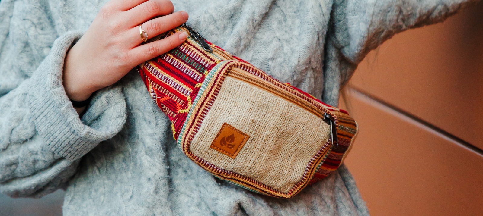 brown and red pouch on white textile