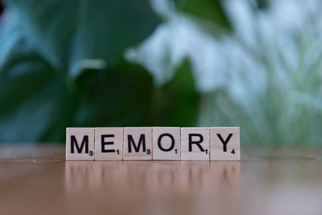 A wooden block spelling memory on a table