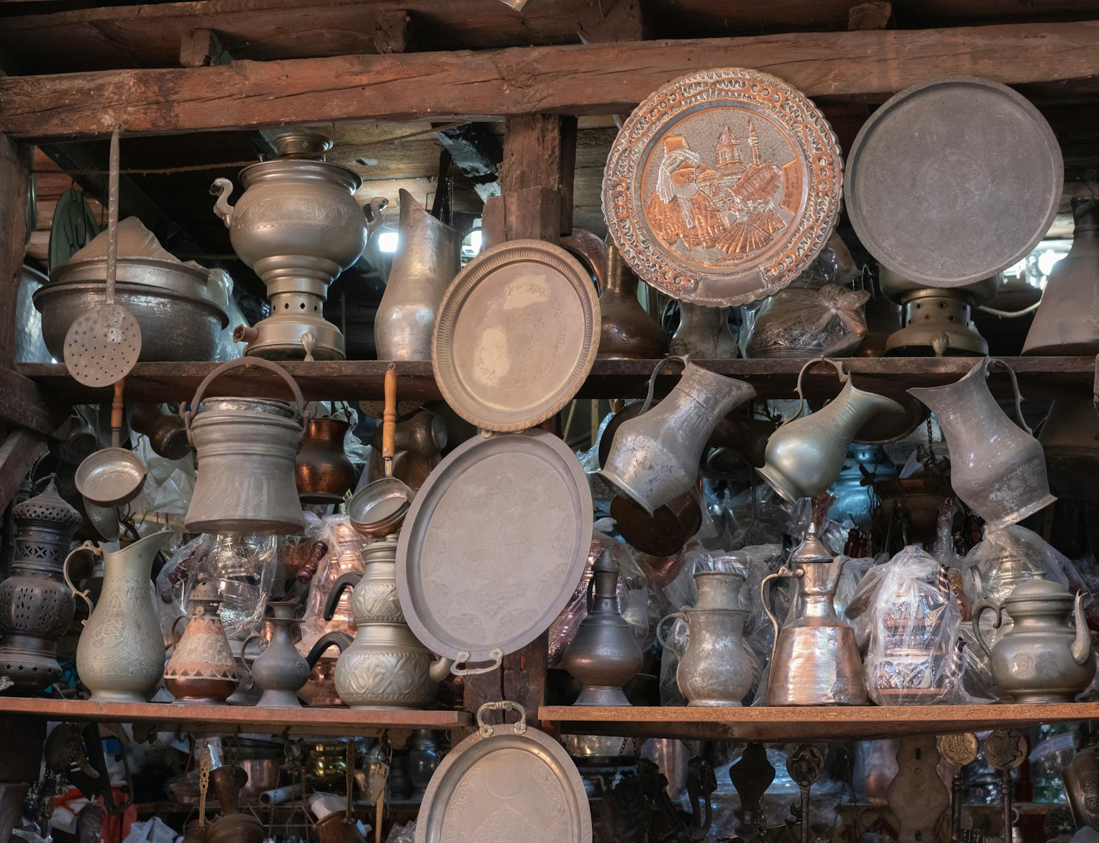 A bunch of pots and pans that are on a shelf