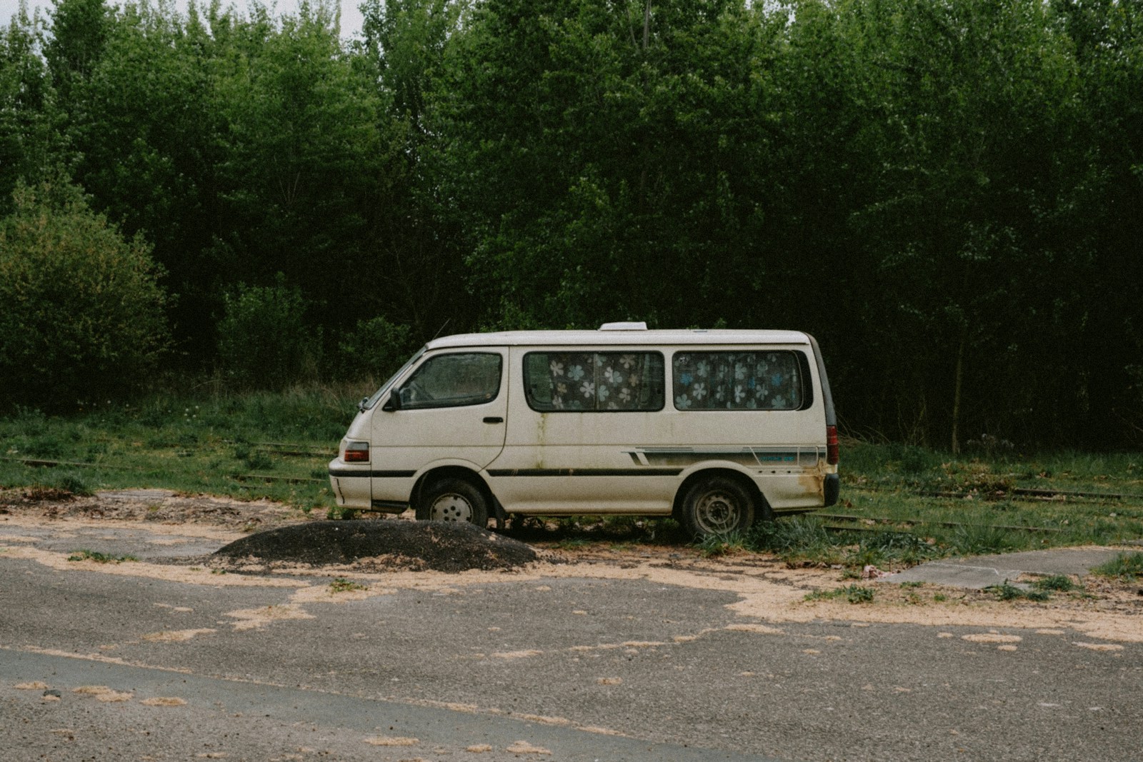 a van that is sitting in the dirt
