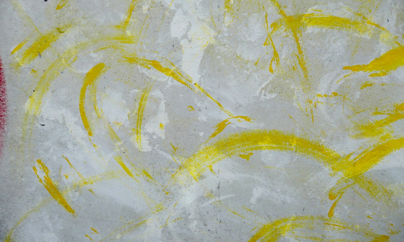 A close up of a piece of paper with yellow paint on it