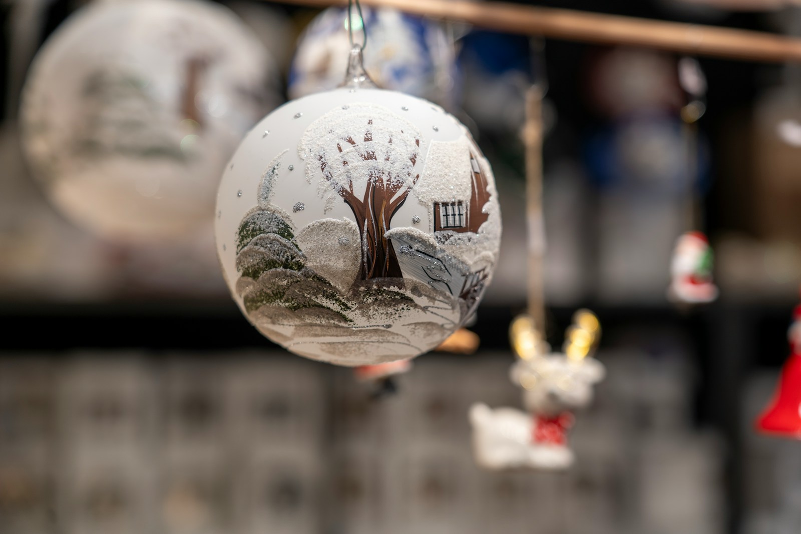 A glass ornament with a picture of a tree on it