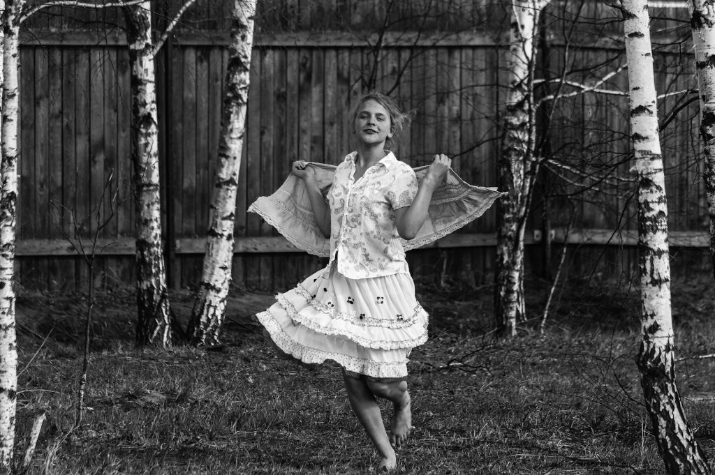 girl in white dress standing on grass field