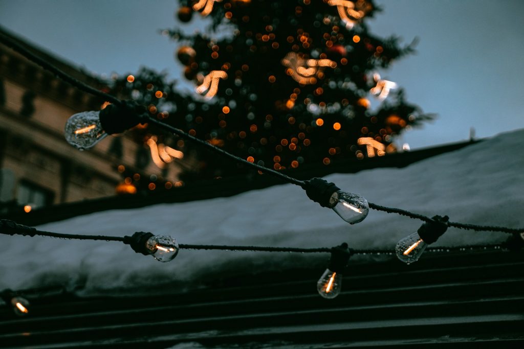 a christmas tree is lit up in front of a building