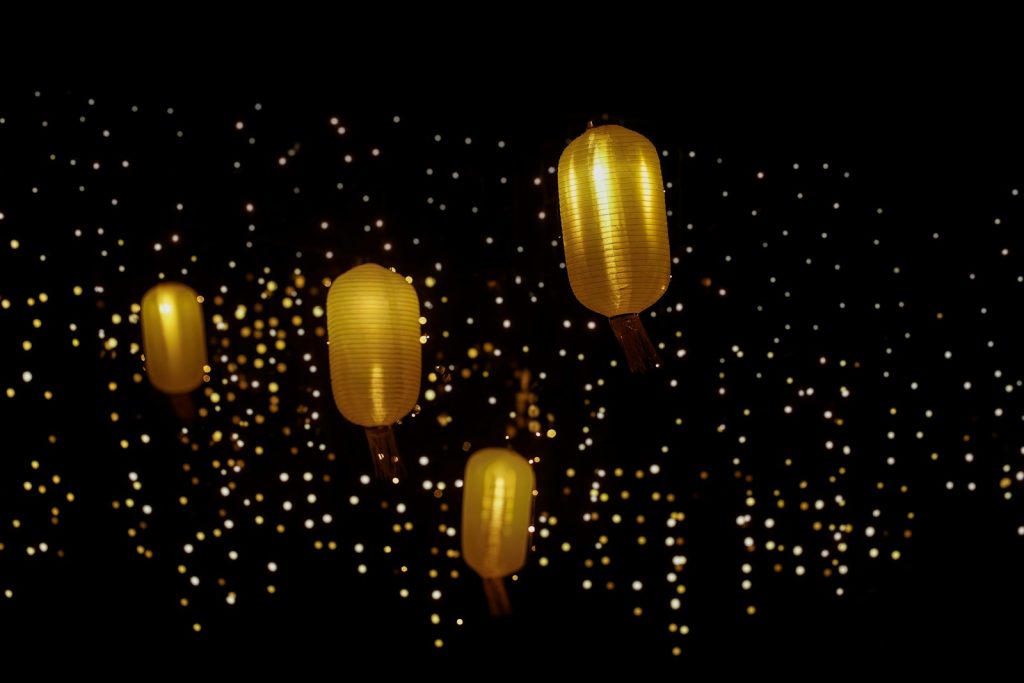 Golden balloons float against a dark background.
