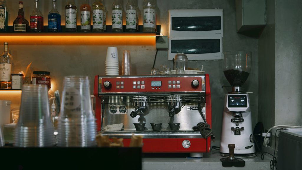 a red coffee machine sitting on top of a counter