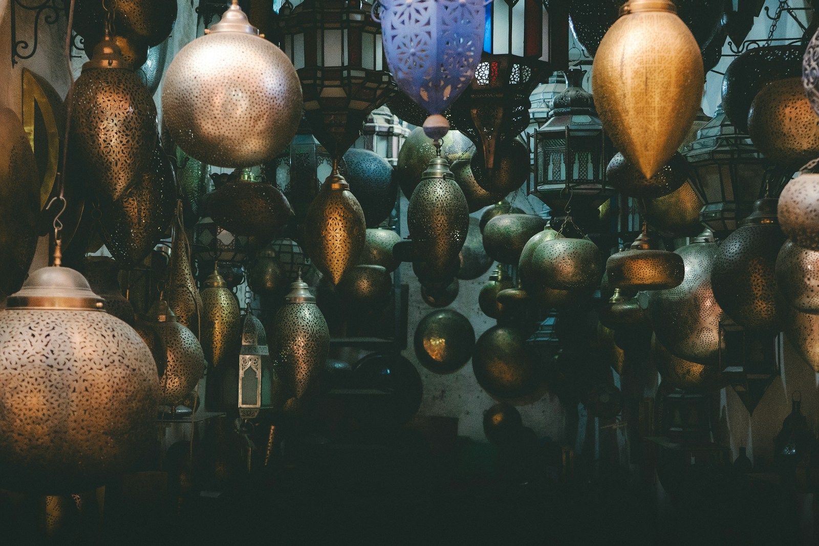 Hanging brass lanterns in a dimly lit market.