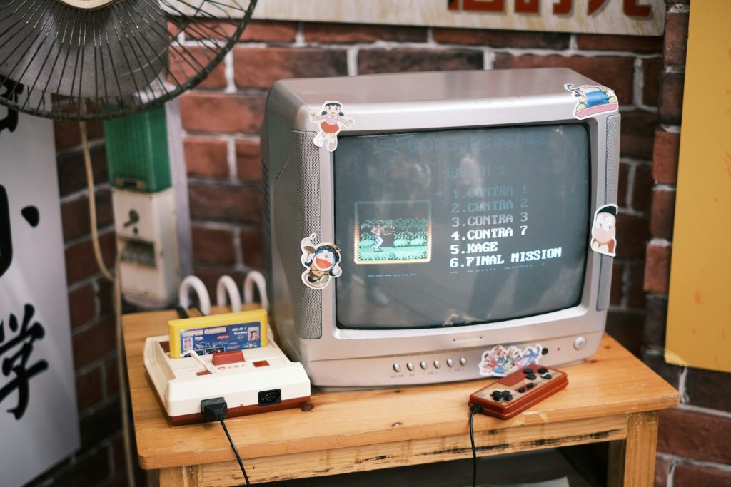 silver crt tv on brown wooden table