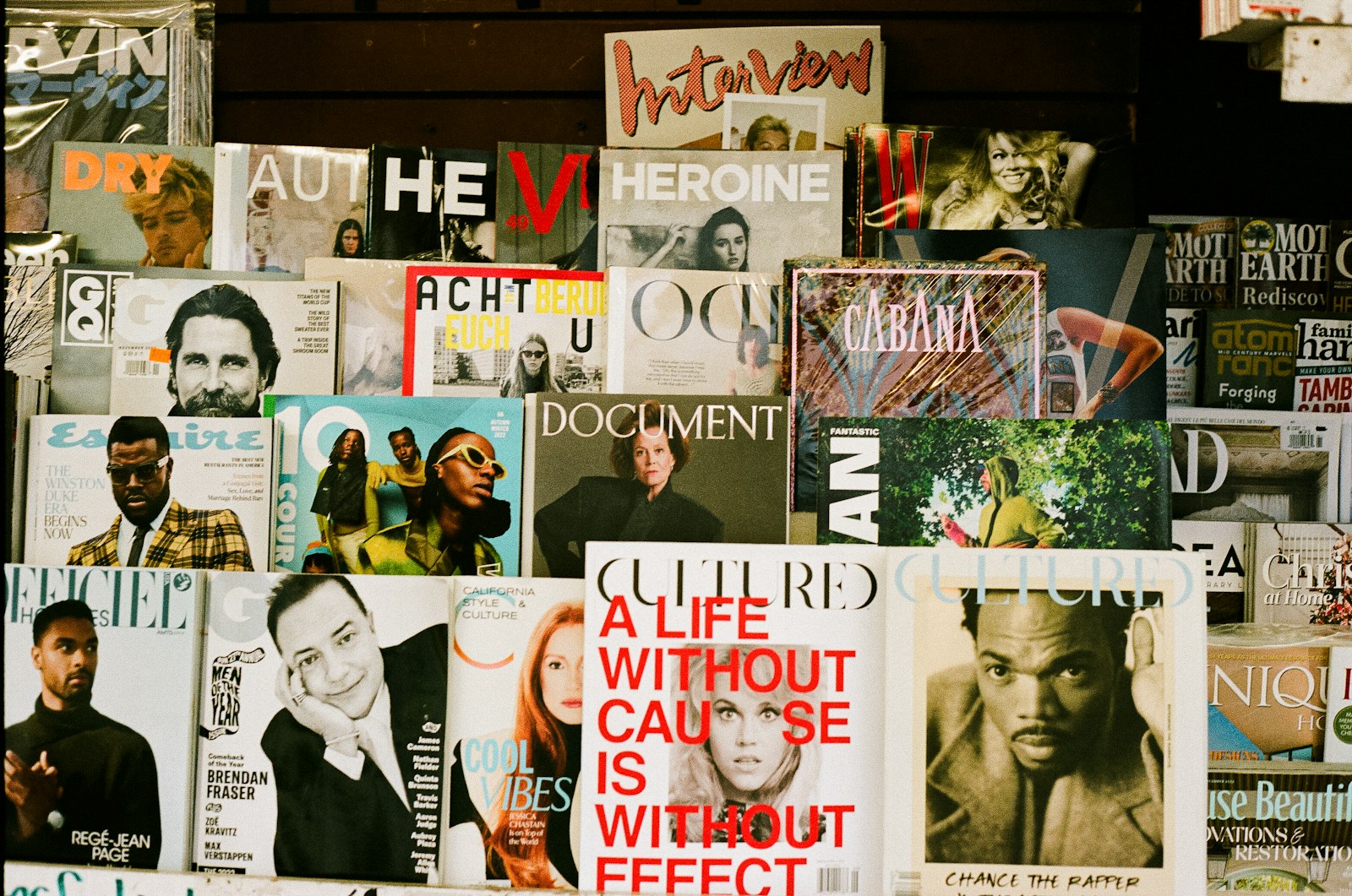 A bunch of magazines are stacked on a wall