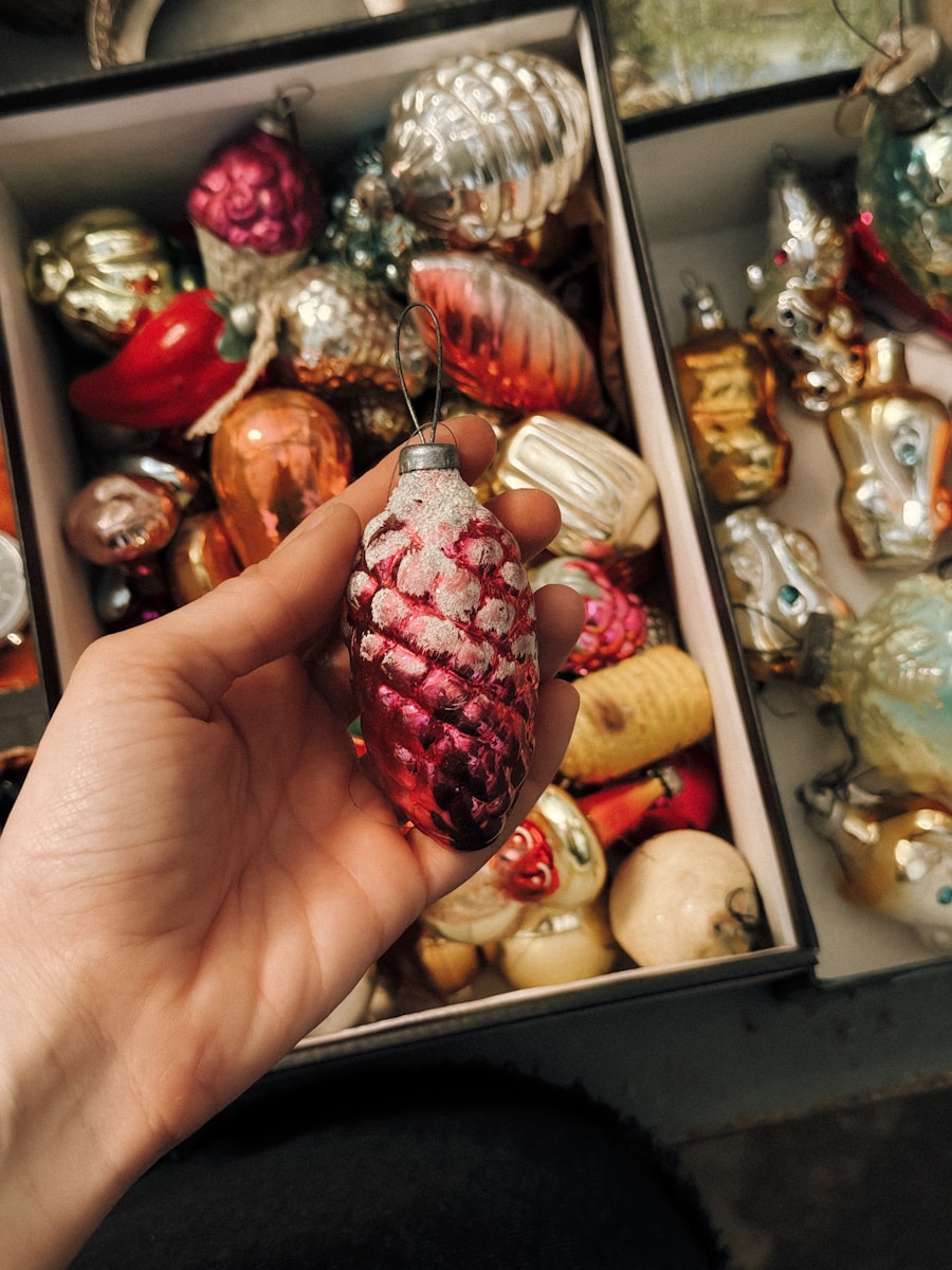 Hand holding a vintage pinecone christmas ornament