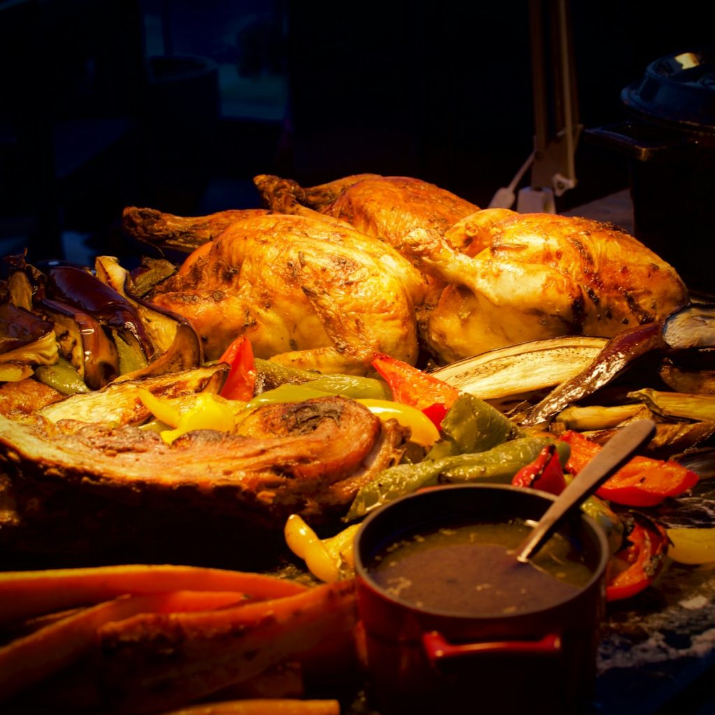 A roasting pan filled with roasted chicken and vegetables
