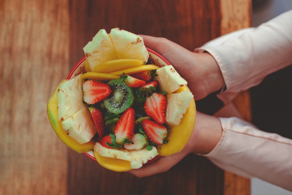 person holding sliced fruit with sliced fruit