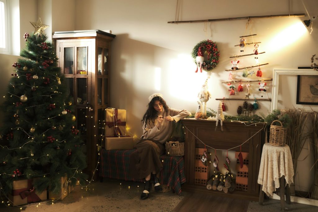 Woman sitting in a cozy christmas decorated room