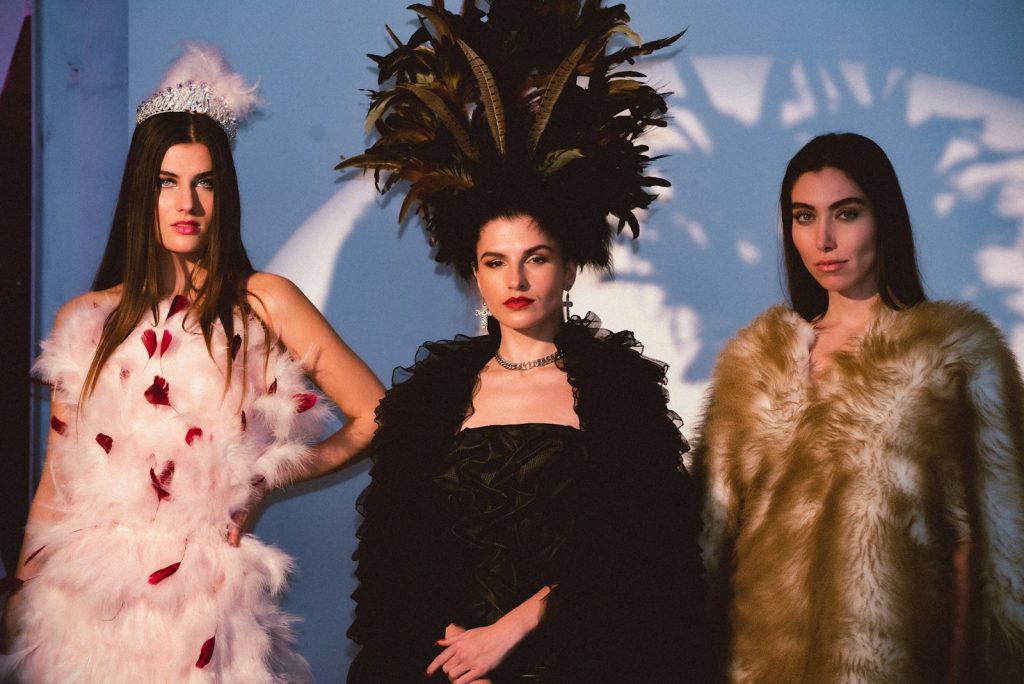 a group of three women standing next to each other