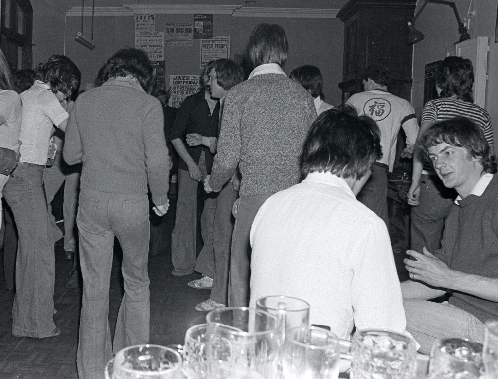 group of people standing in front of table