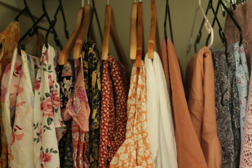 A rack of clothing hanging on a wall