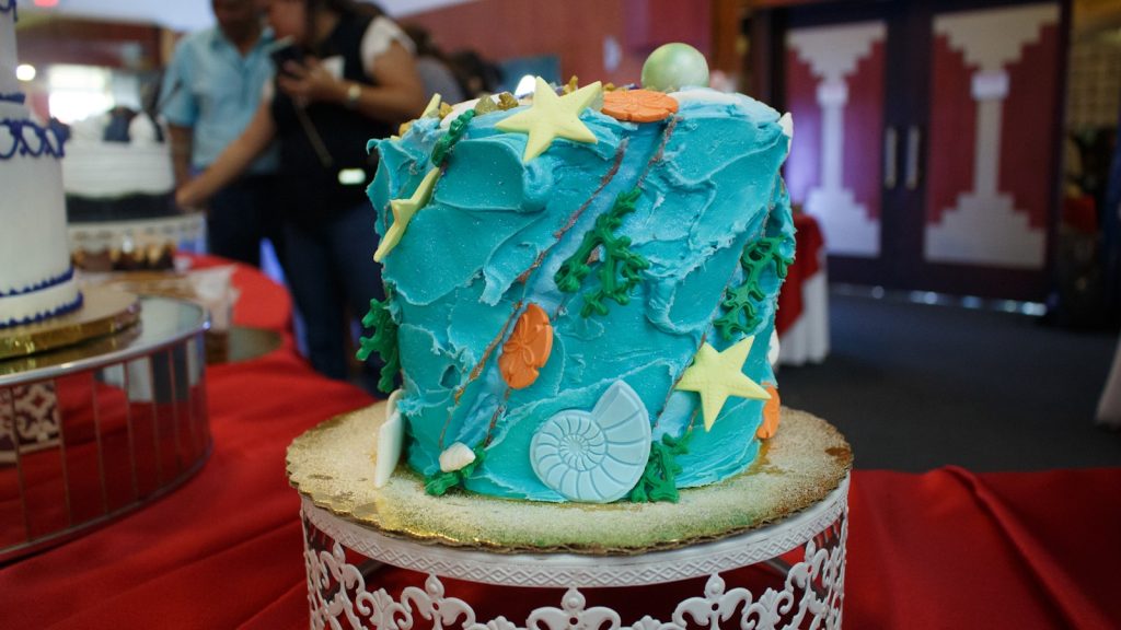 Ocean-themed cake decorated with shells and stars.