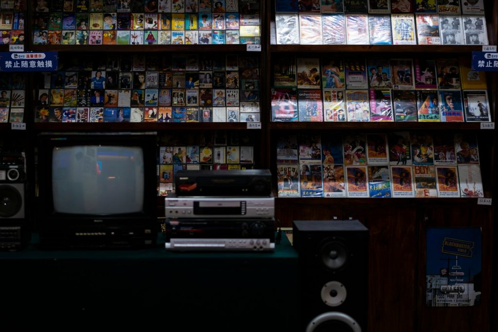 a television sitting on top of a table in front of a book shelf