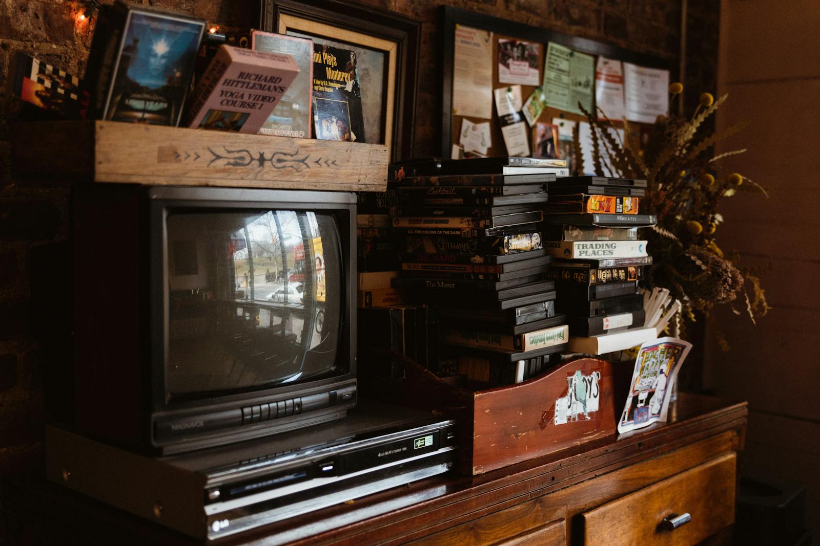 Classic setup of a retro-oriented living area featuring an old TV, VHS tapes, and vintage decor.