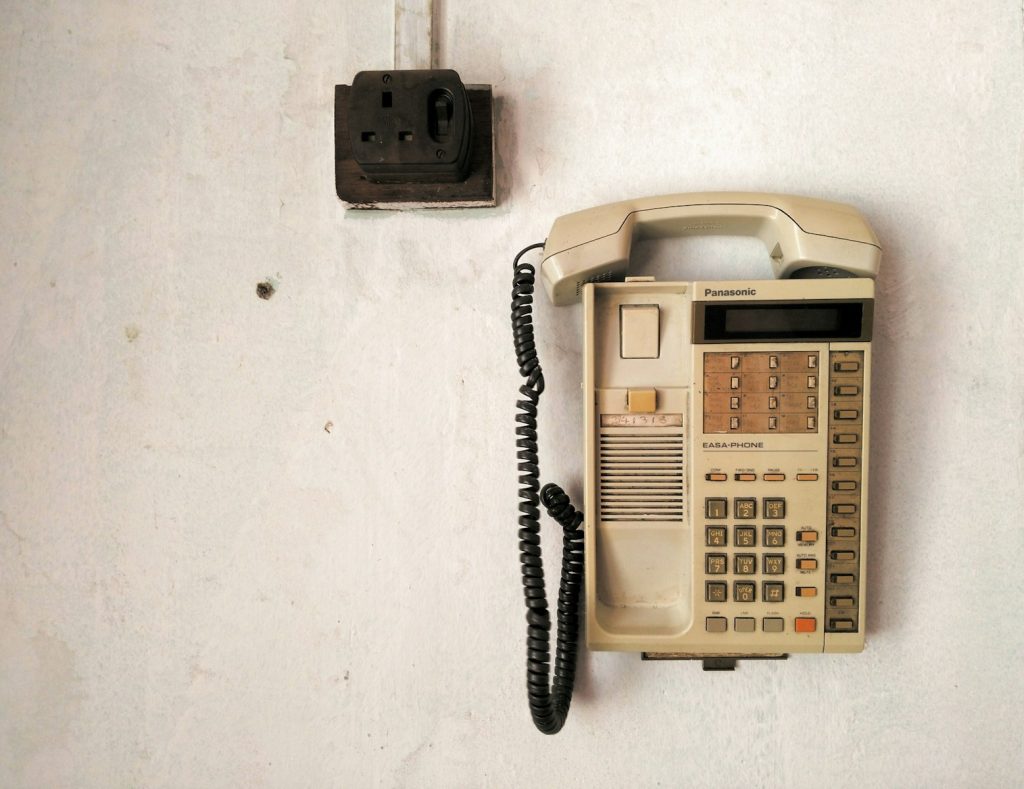 beige telephone on white surface