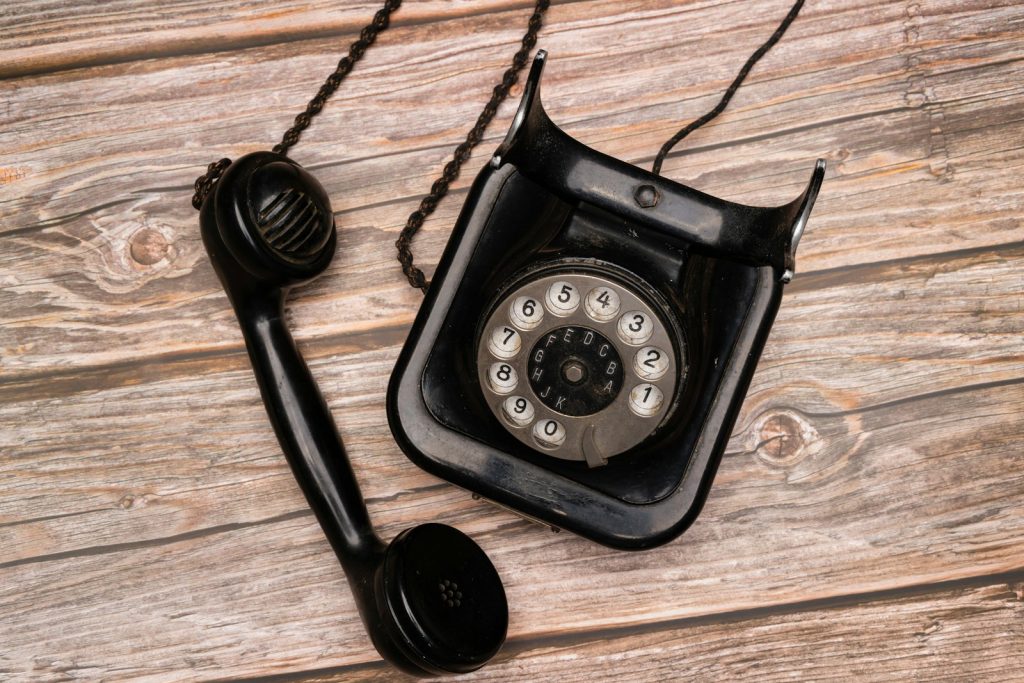 a black telephone on a wooden surface