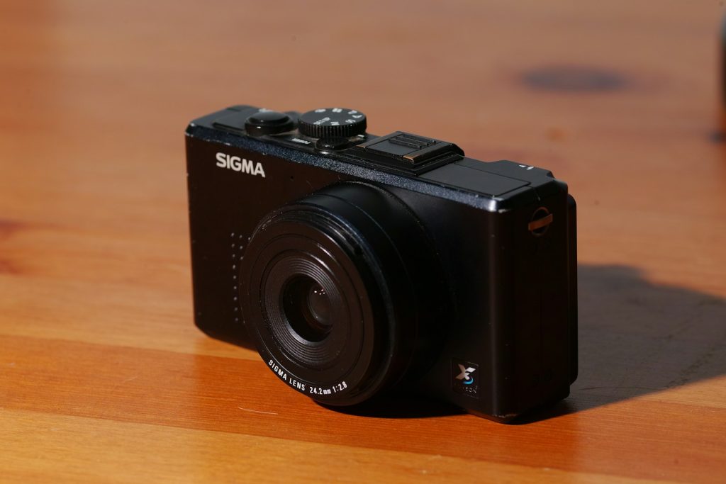black nikon dslr camera on brown wooden table