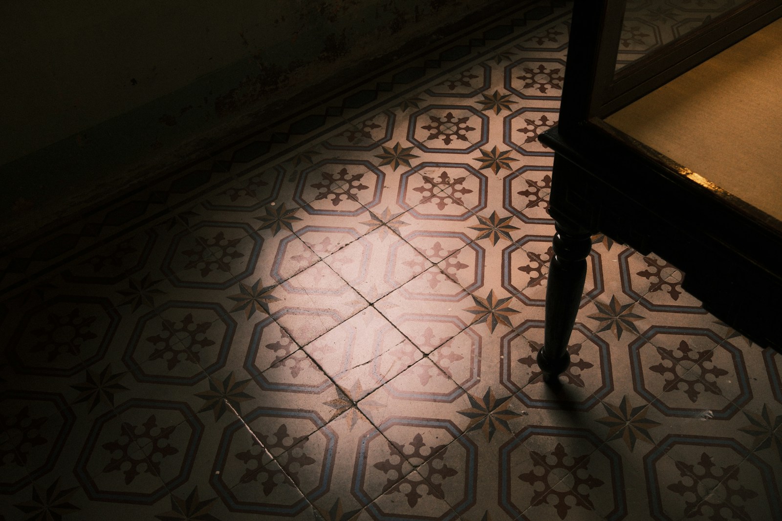 Ornate tiled floor with sunlight patterns
