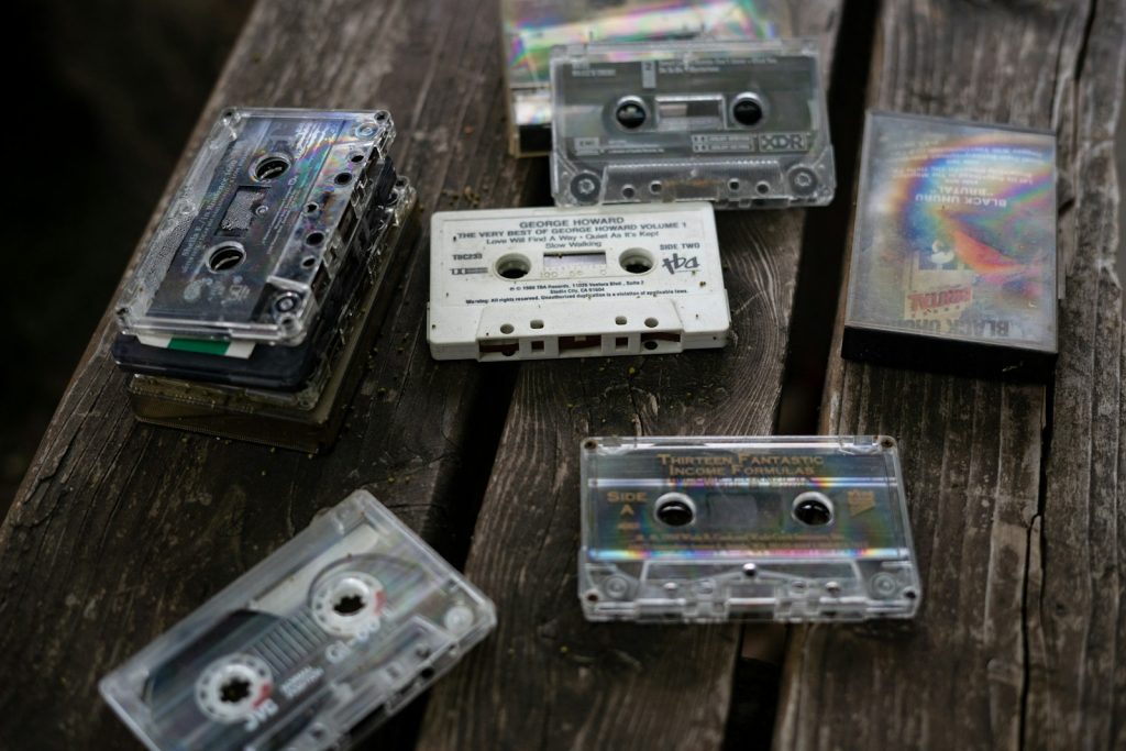 a group of cassettes sitting on top of a wooden table