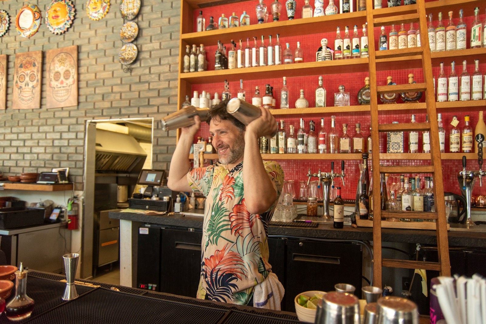 A man standing in front of a counter in a restaurant