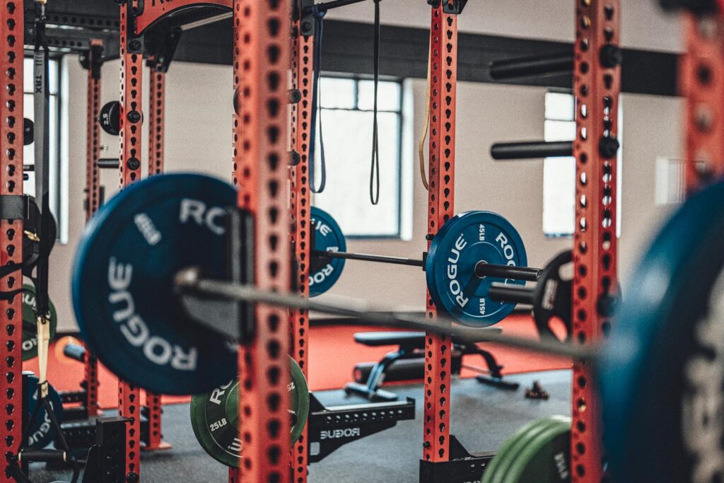 Close-up view of gym equipment with barbells and weight plates, perfect for strength training enthusiasts.