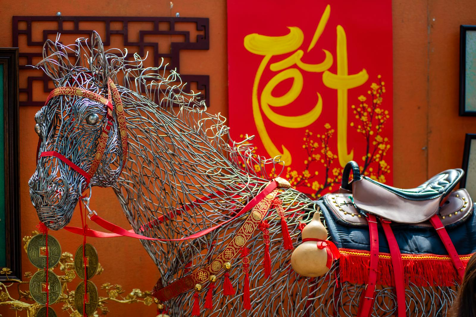 Colorful wire horse sculpture and Tet decorations create a festive scene outdoors.