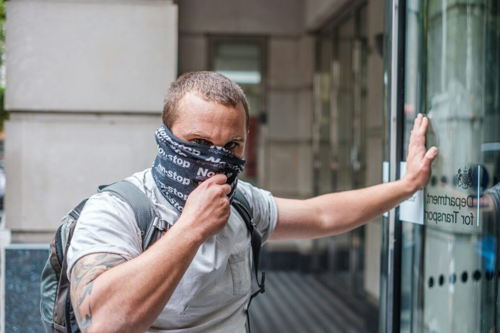 man in grey shirt wearing black and grey scarf