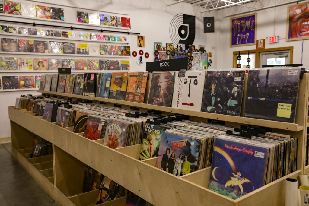 Browse vinyl records at a retro store in Tulsa, OK, featuring classic rock and eclectic album covers.