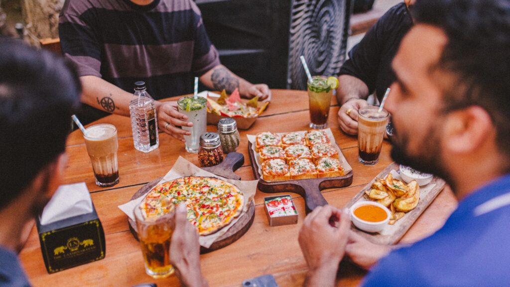people eating pizza at a table