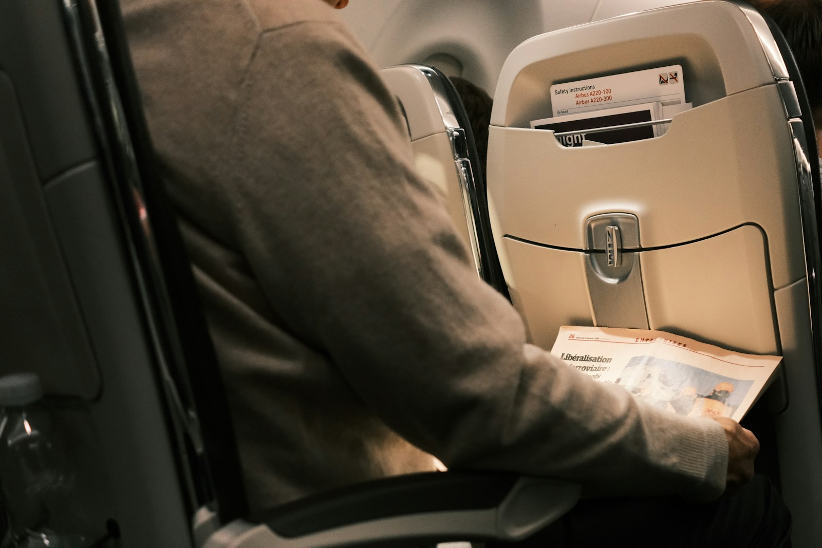A man sitting in a seat on an airplane