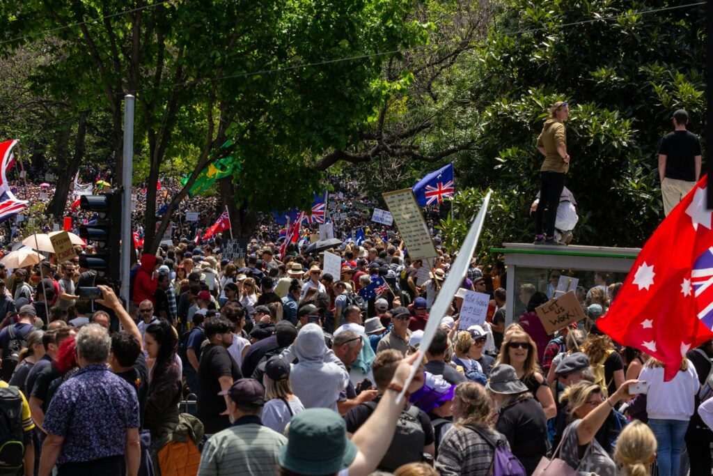a large crowd of people walking down a street