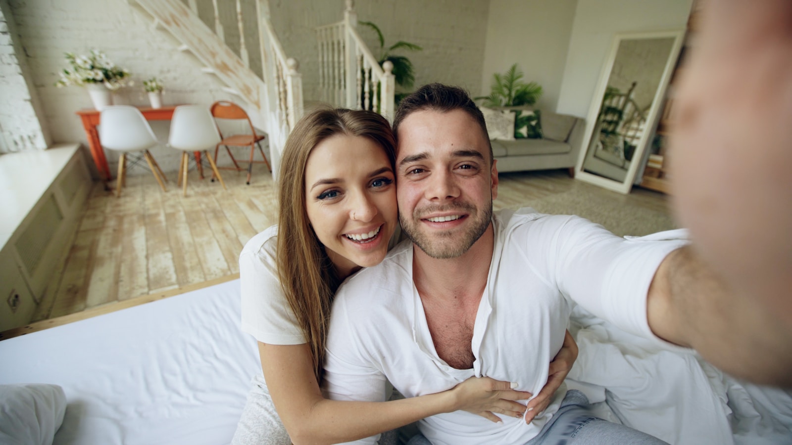 Couple taking a selfie in bed