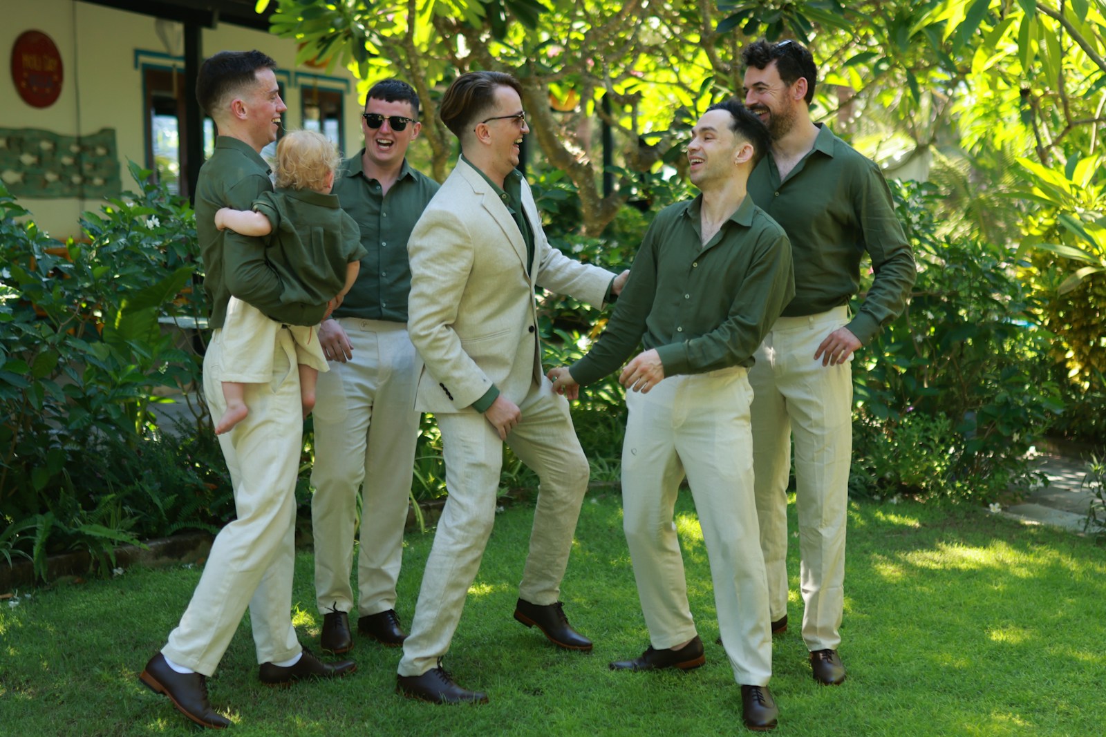 Six men in matching outfits standing outdoors.