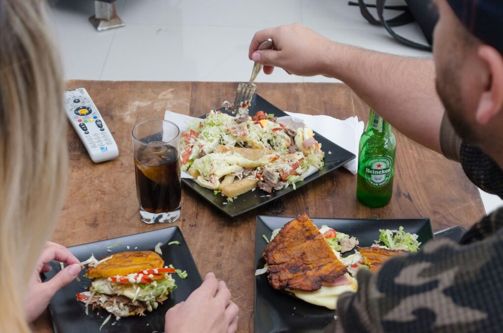 person holding fork and bread knife